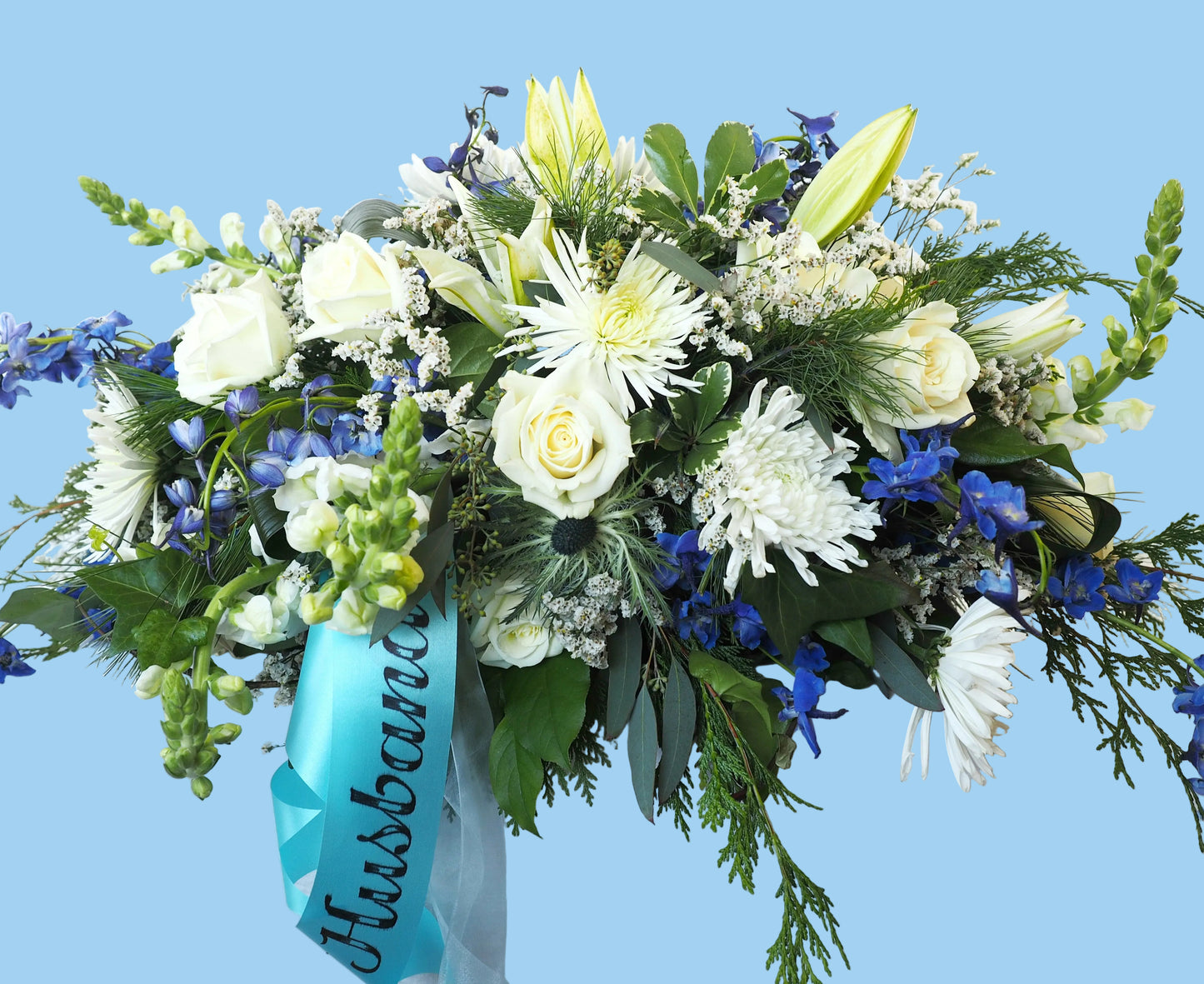 Floral arrangement with white and blue flowers on a white background