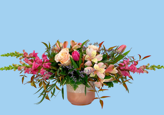 Colorful flower arrangement in a vase on a white background