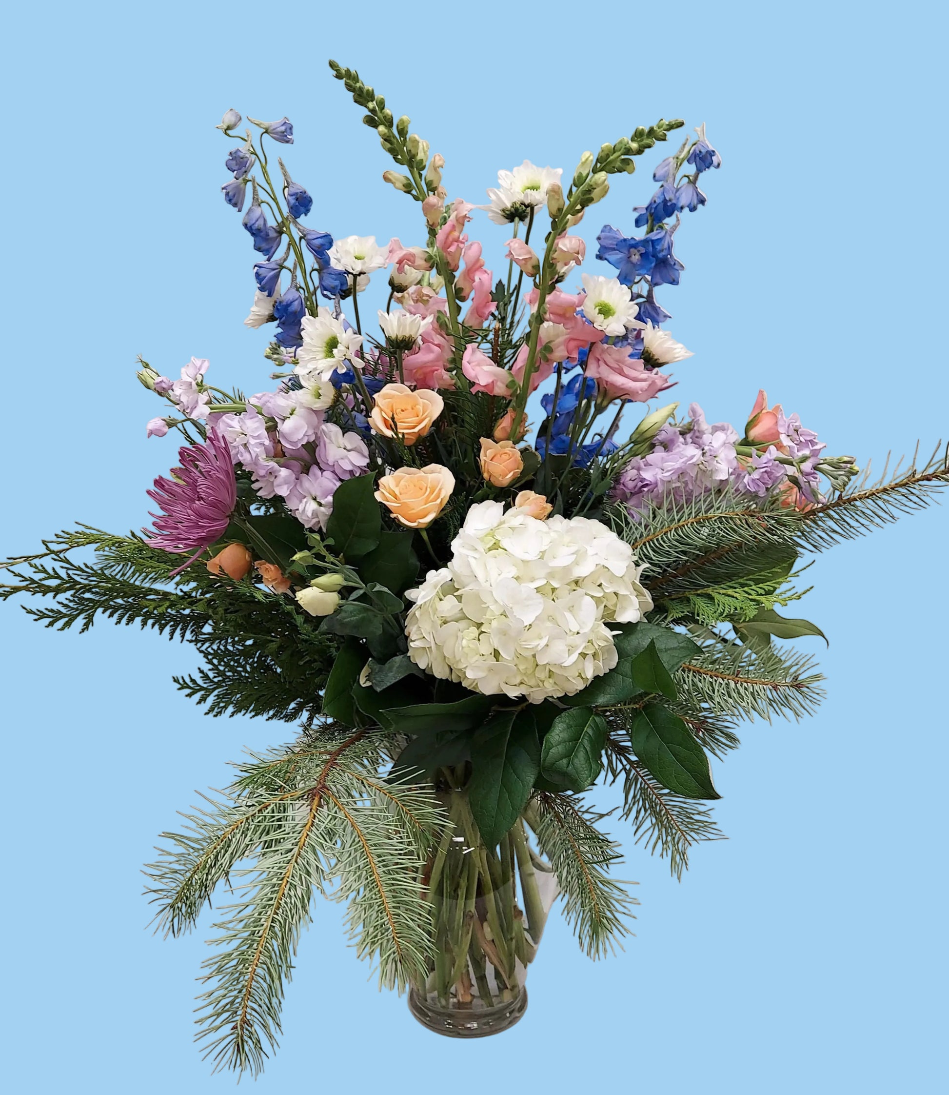 Bouquet of flowers in a clear vase on a white background
