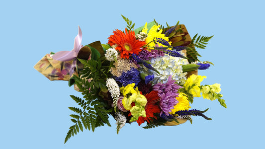 Bouquet of colorful flowers on a white tablecloth with a white background